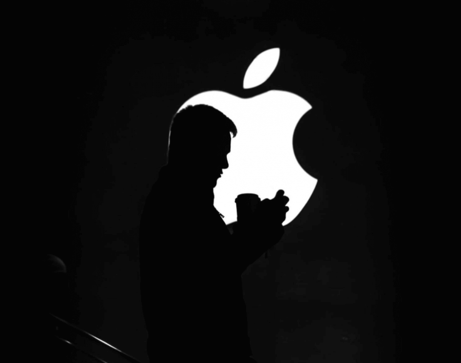 Man standing in front of Apple logo