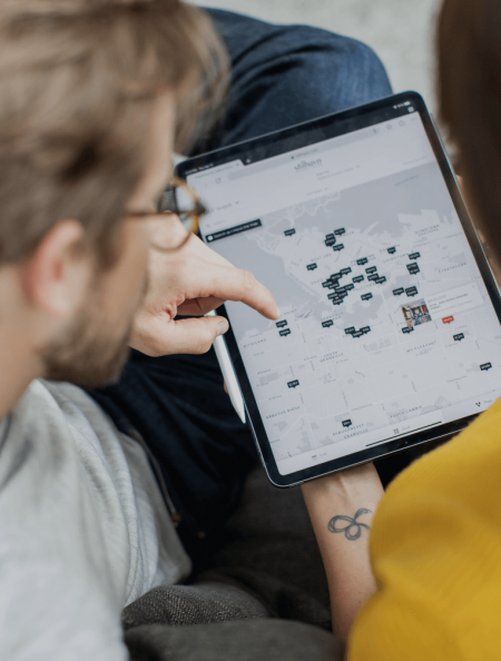 Couple looking at home listings on a map