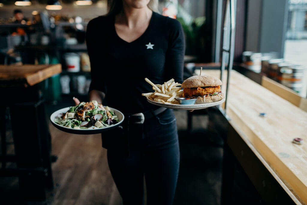 Server delivering food to a table