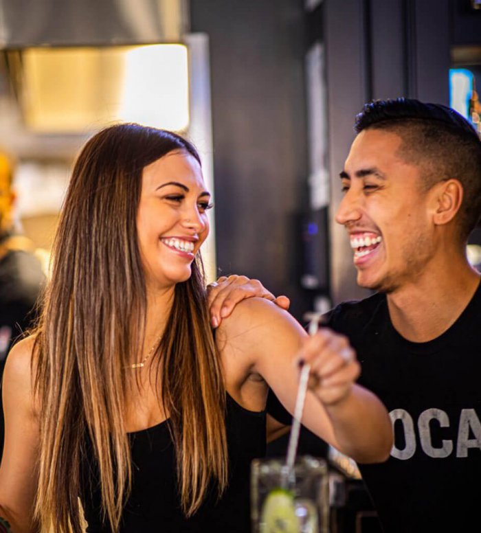 Bartender and server laughing