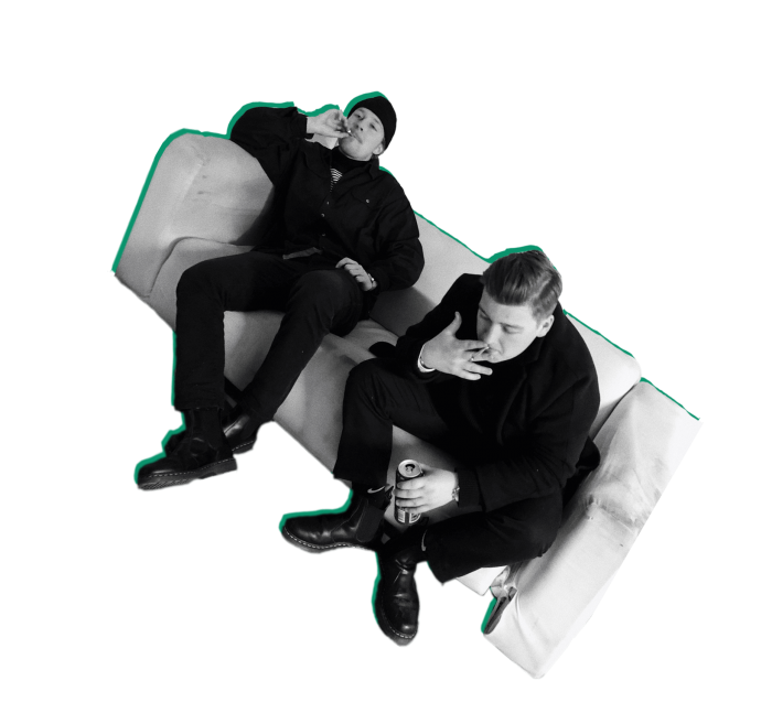 2 guys smoking on a couch