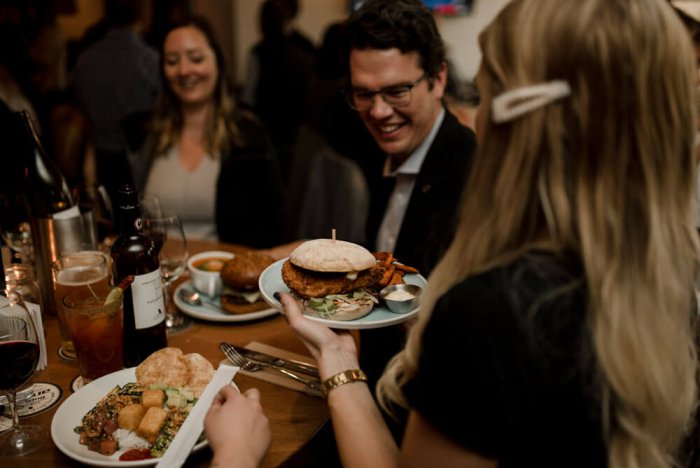 server giving dinner to customers