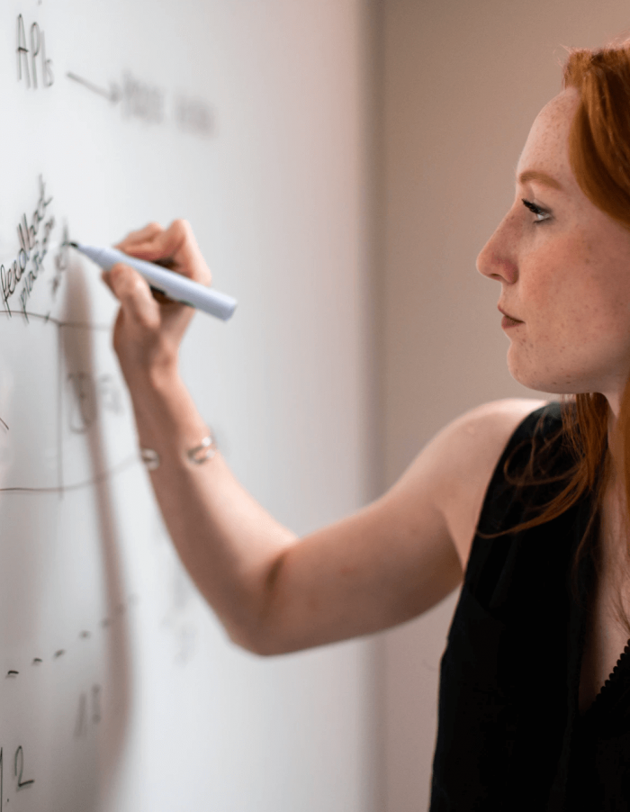 Woman writing on a whiteboard