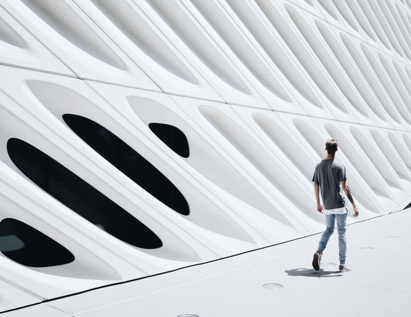 Man walking infront of modern building