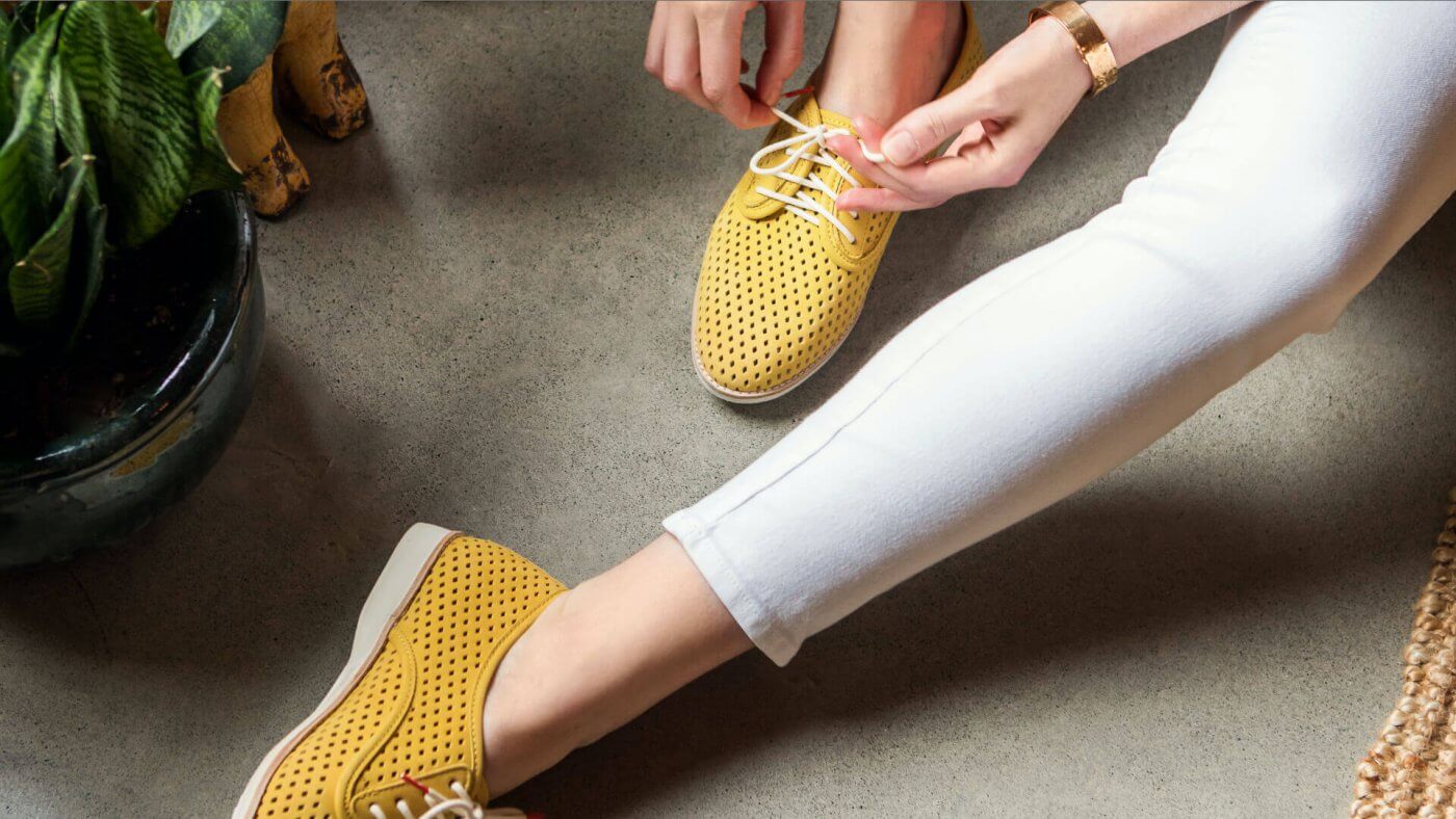 woman putting on ketch shoes